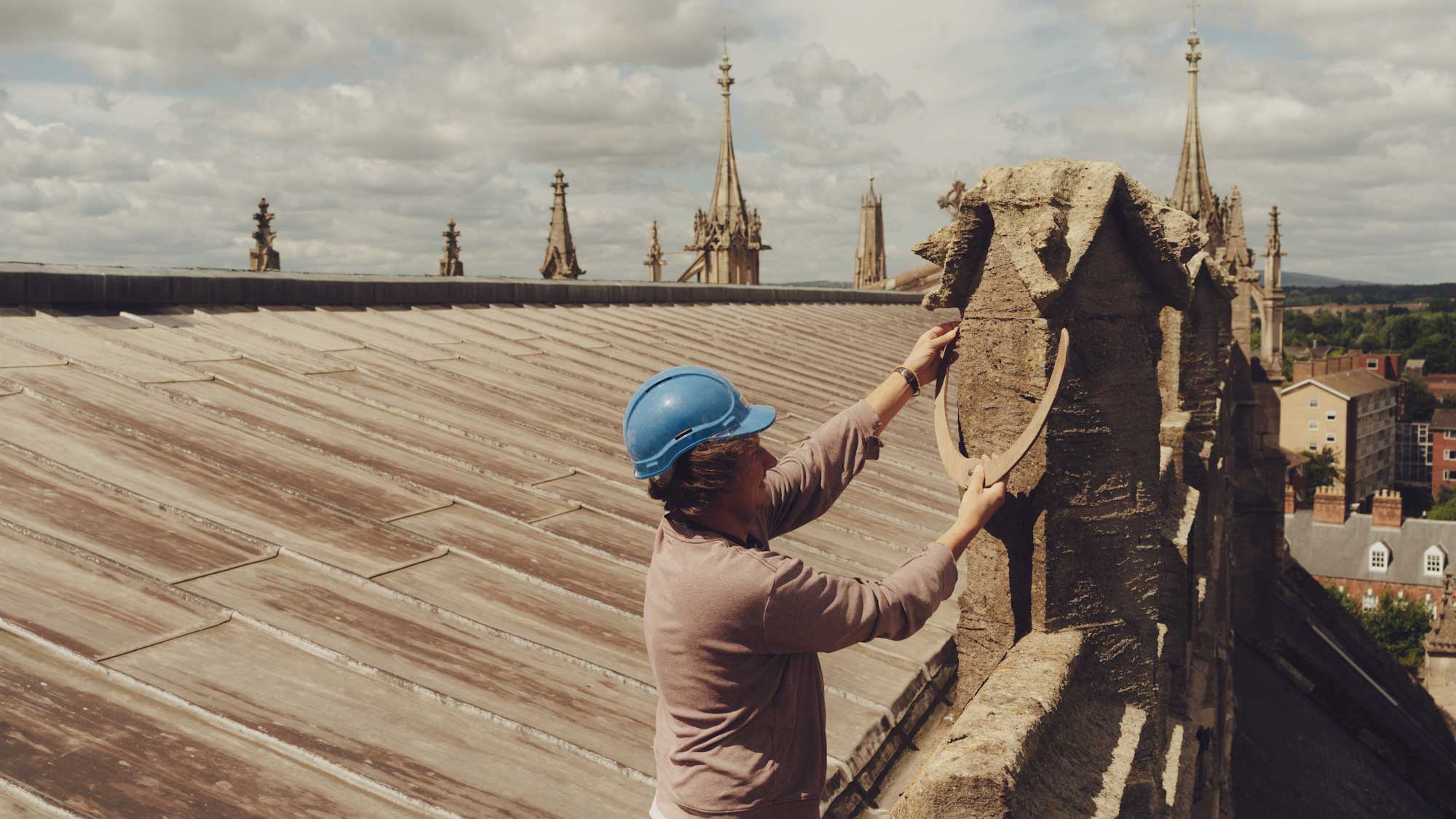Stonemason on the roof of Gloucester Cathedral